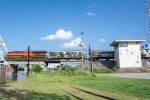 A westbound grain train passes the bridge control tower